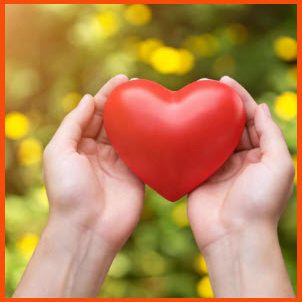 Mit einem Klick spenden Rote Herzform, gehalten von zwei Händen, vor unscharfem, grünem Hintergrund.